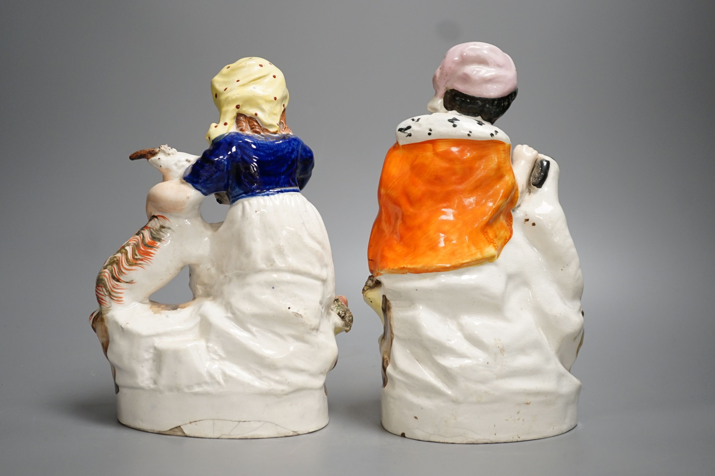 A pair of Victorian Staffordshire child and animal groups - tallest 23.5cm